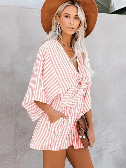 Pink striped jumpsuit with deep V and trumpet sleeves