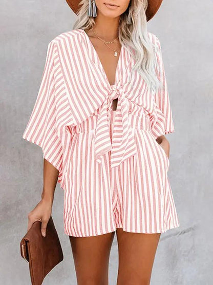 Pink striped jumpsuit with deep V and trumpet sleeves
