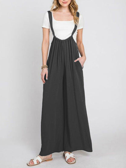 Front view of black jumpsuit with wide legs and pockets