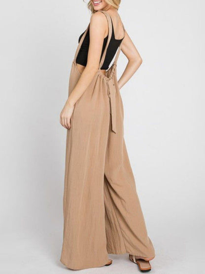 Side view of beige jumpsuit with lace-up and pockets