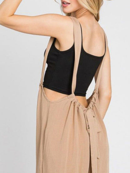 Close-up of beige jumpsuit lace-up back detail