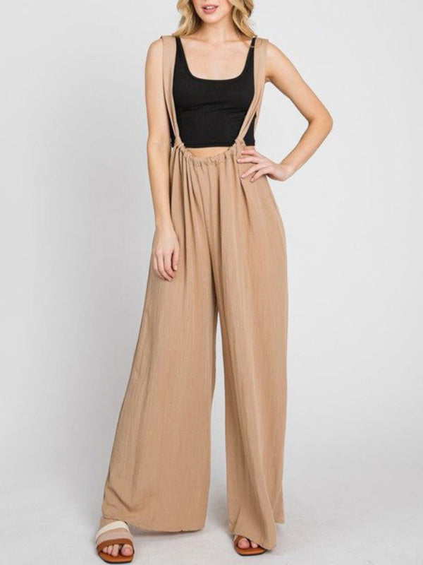Front view of beige jumpsuit with wide legs and pockets