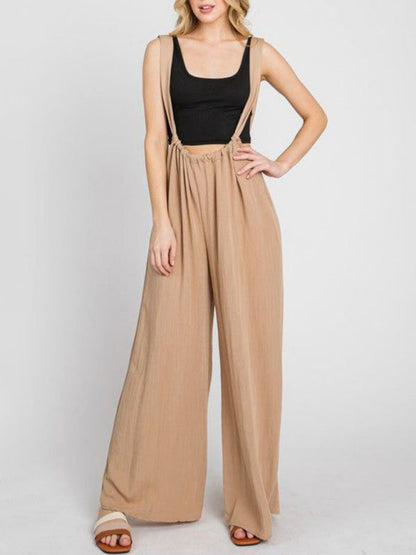 Front view of beige jumpsuit with wide legs and pockets