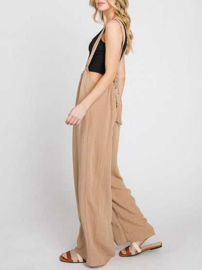 Side view of beige wide-leg jumpsuit with lace-up