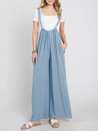 Front view of blue jumpsuit with wide legs and pockets