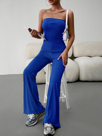Blue tube top jumpsuit, seated pose, stylish look