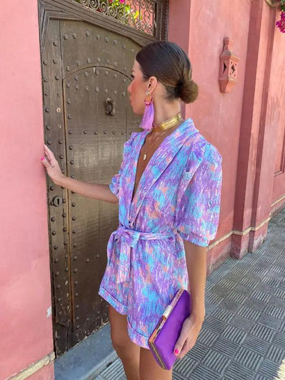 Purple printed jumpsuit with deep V-neck and tie waist