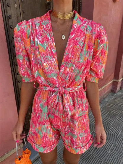 Vibrant printed jumpsuit with deep V-neck and bubble sleeves