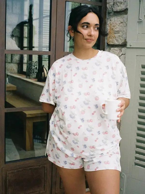 Woman holding mug in printed pajamas set