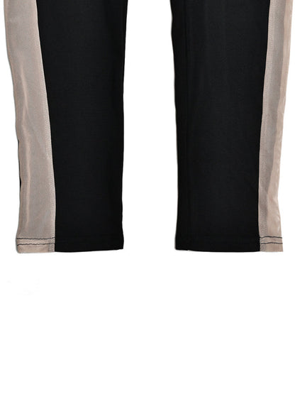 Close-up of trousers stitching on black jumpsuit