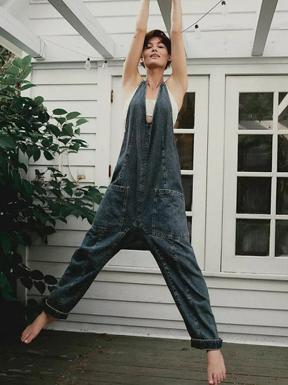 Dark denim V-neck jumpsuit with outdoor setting