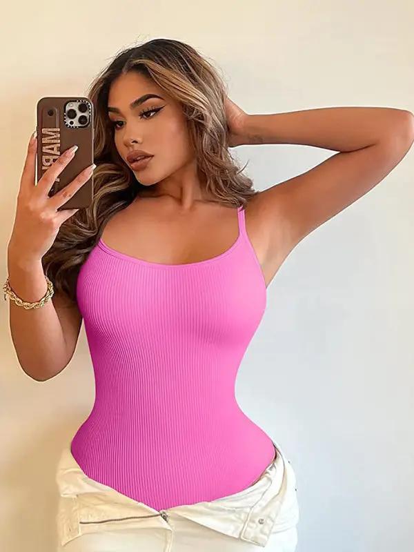 Pink ribbed tank top bodysuit with white pants