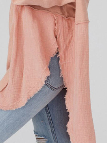 Close-up of side slit detail on peach pullover
