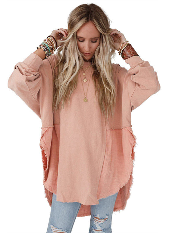 Model wearing peach side slit pullover with jeans