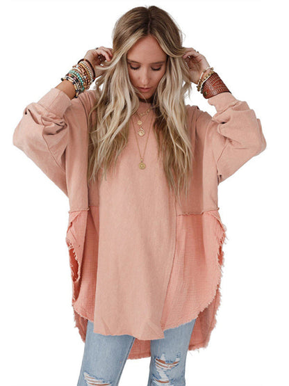 Model wearing peach side slit pullover with jeans