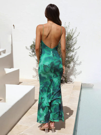 Back view of green printed backless suspender dress