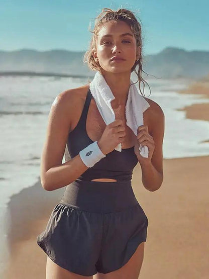 Black hollow cross loose fitness tank top jumpsuit beach scene