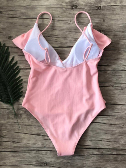 Back view of pink ruffled one-piece swimsuit