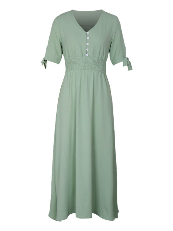 Green V-neck belted midi dress with button details.