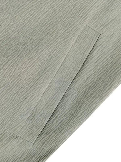Close-up of fabric texture on green jumpsuit