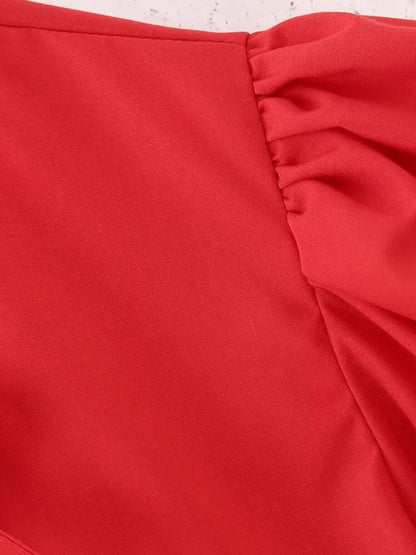 Detail of red puff sleeve on shirt top