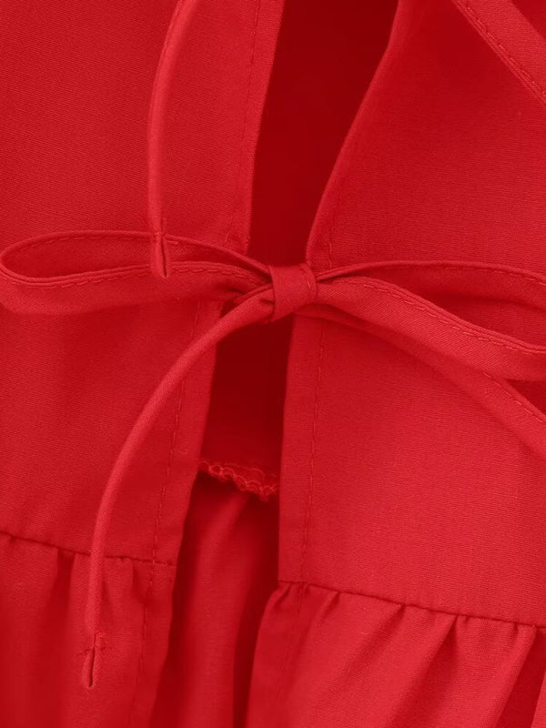 Close-up of red strappy bow detail on shirt top