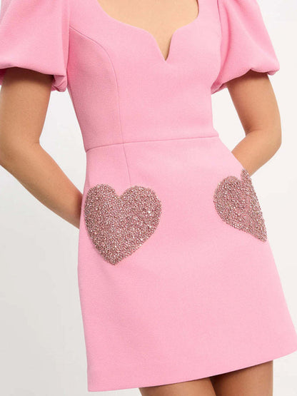 Close-up of pink dress with heart sequin details