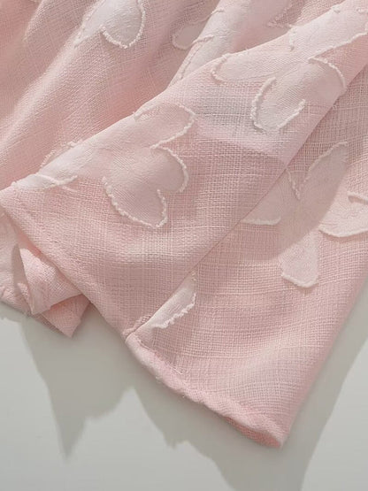 Pink flower-cut fabric texture close-up