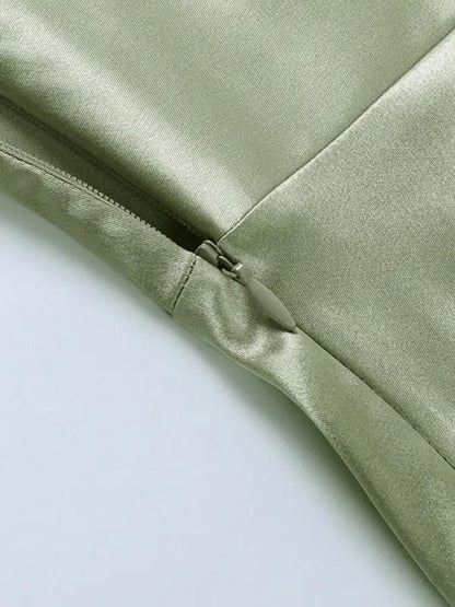 Close-up of green dress zipper detail