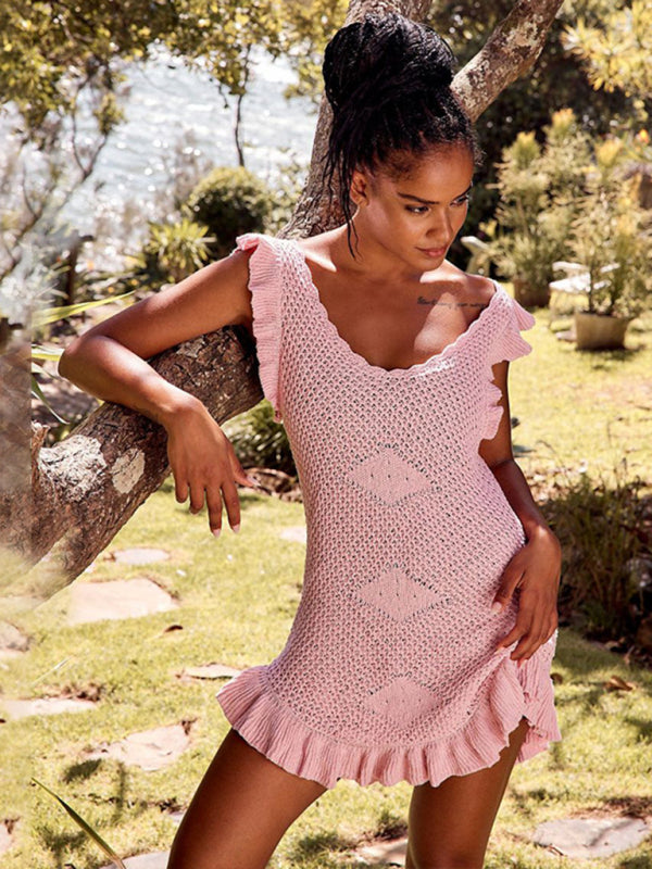 Woman wearing pink ruffle dress with ear sleeves by a tree