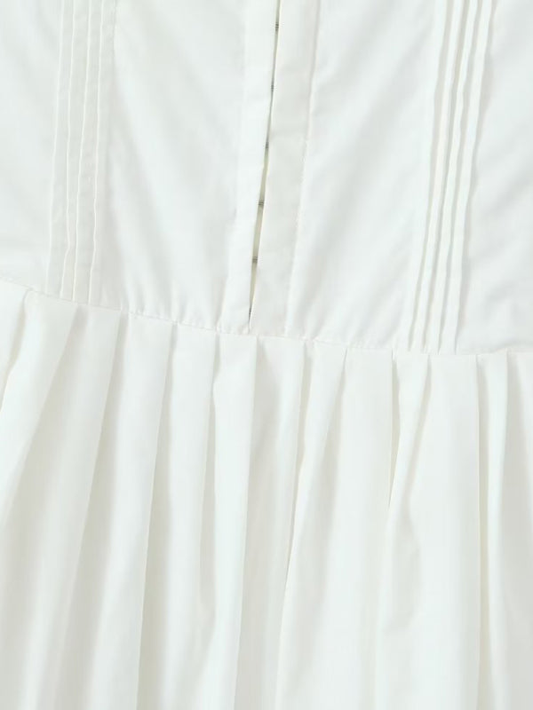 Pleated skirt detail of white short dress