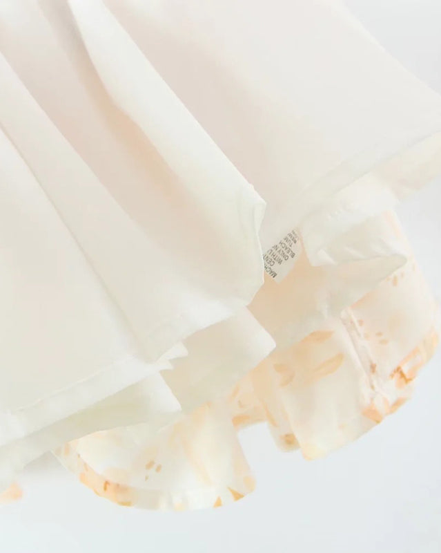 Close-up of dress hem with layered fabric detail