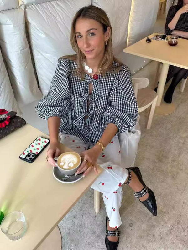 Woman in checkered blouse with latte at cafe