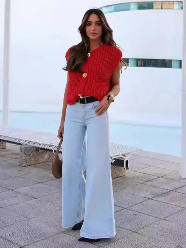 Woman in red knitted vest cardigan and wide-leg jeans