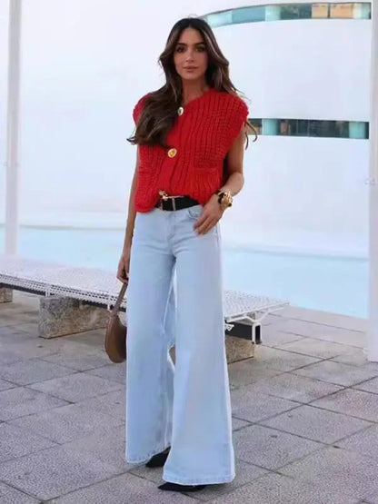 Woman in red knitted vest cardigan and wide-leg jeans
