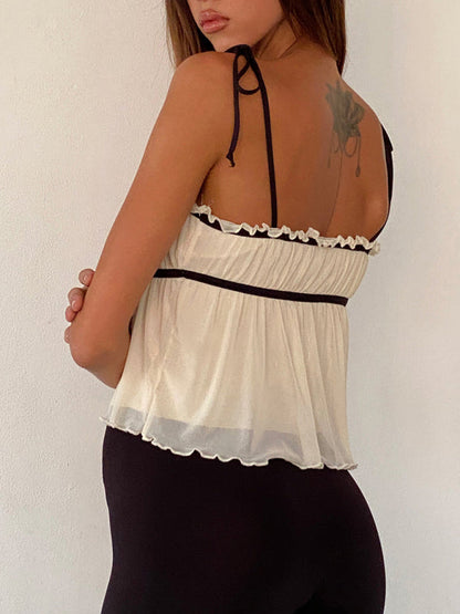 Back view of white lace suspender top with black straps