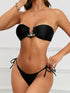 Black shiny fabric bikini with split design, angled view