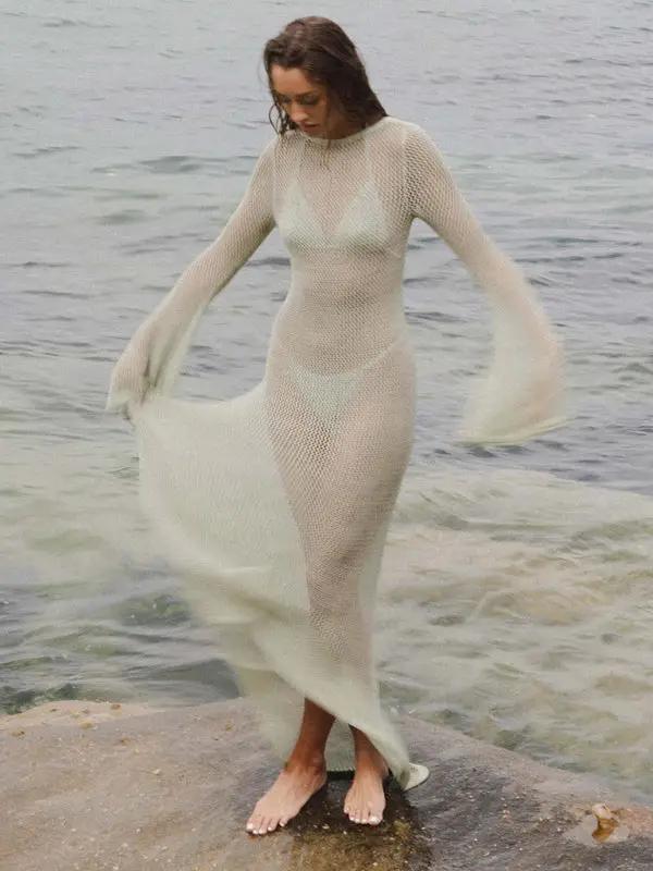White knitted see-through maxi dress, standing by water