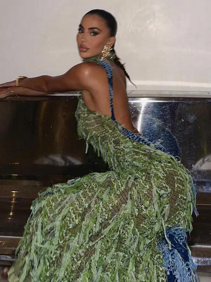 Model wearing green tassel dress in side pose