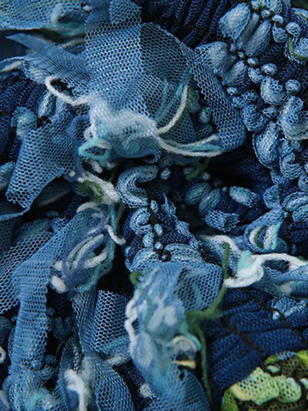 Close-up of blue and green tassel fabric texture