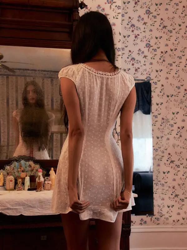 Back view of white lace dress with intricate design