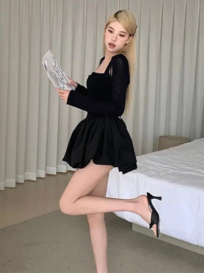 Black dress standing, holding a newspaper