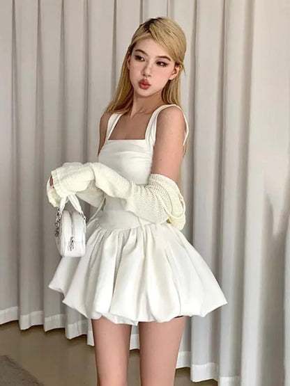 White dress with gloves, holding a purse