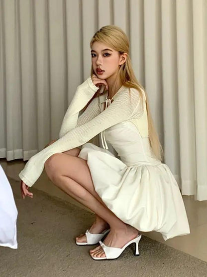White dress with long sleeves, squatting pose
