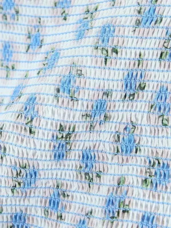 Close-up of blue floral pleated fabric texture