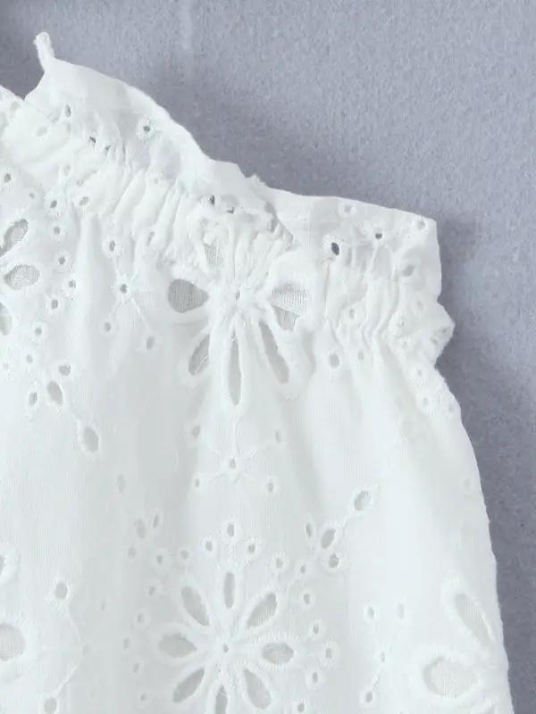 Close-up of white lace fabric with floral pattern