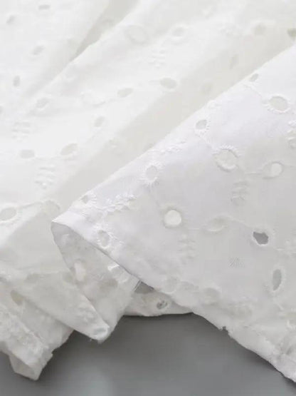 Close-up of embroidered fabric on white dress