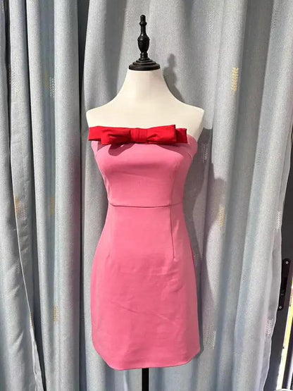 Pink tube top dress with red bow on mannequin