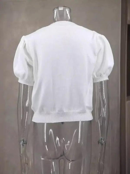 Back view of white short-sleeved sweater on mannequin