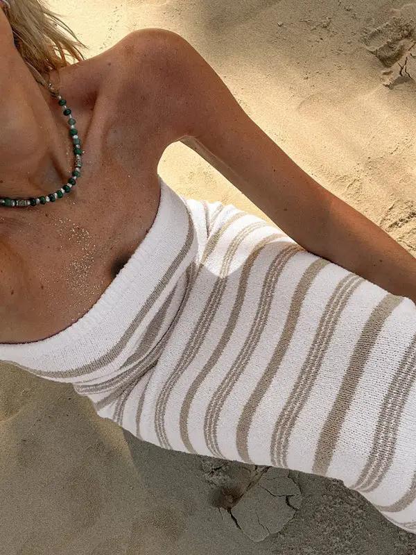 Close-up of striped tube top skirt on sandy beach